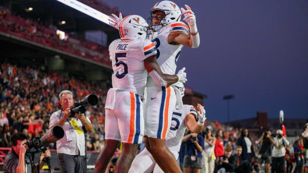 Virginia Cavaliers running back Kobe Pace (5) celebrates with teammates after scoring a touchdown during the first quarter against the Maryland Terrapins at SECU Stadium. 